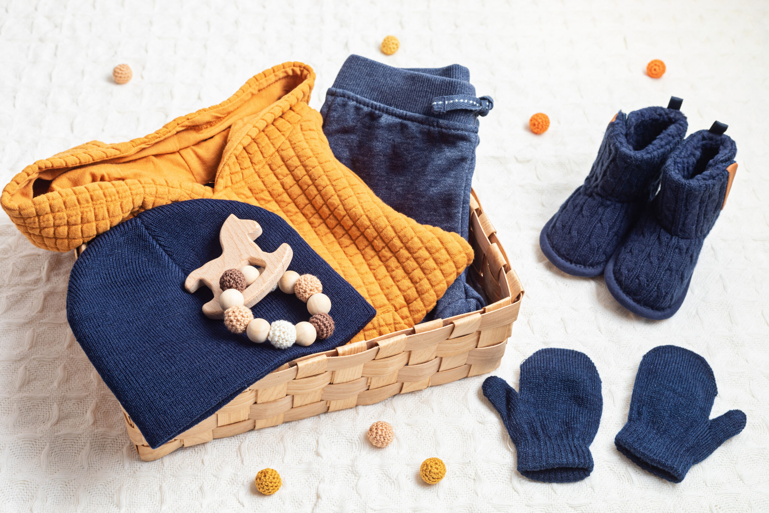Set of cute organic baby clothes, toys and booties. Heartwarming present for cold weather. Newborn gifts for Christmas and baby shower, care package, donation idea.